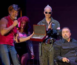 West Hollywood City Councilman John Duran presents Tim Curry, the star of ‘The Rocky Horror Picture Show, ’ a key to the city during the city’s Halloween Carnaval celebration Oct. 31. The film marked the 40th anniversary of its release last week. (Photo by Jon Viscott)